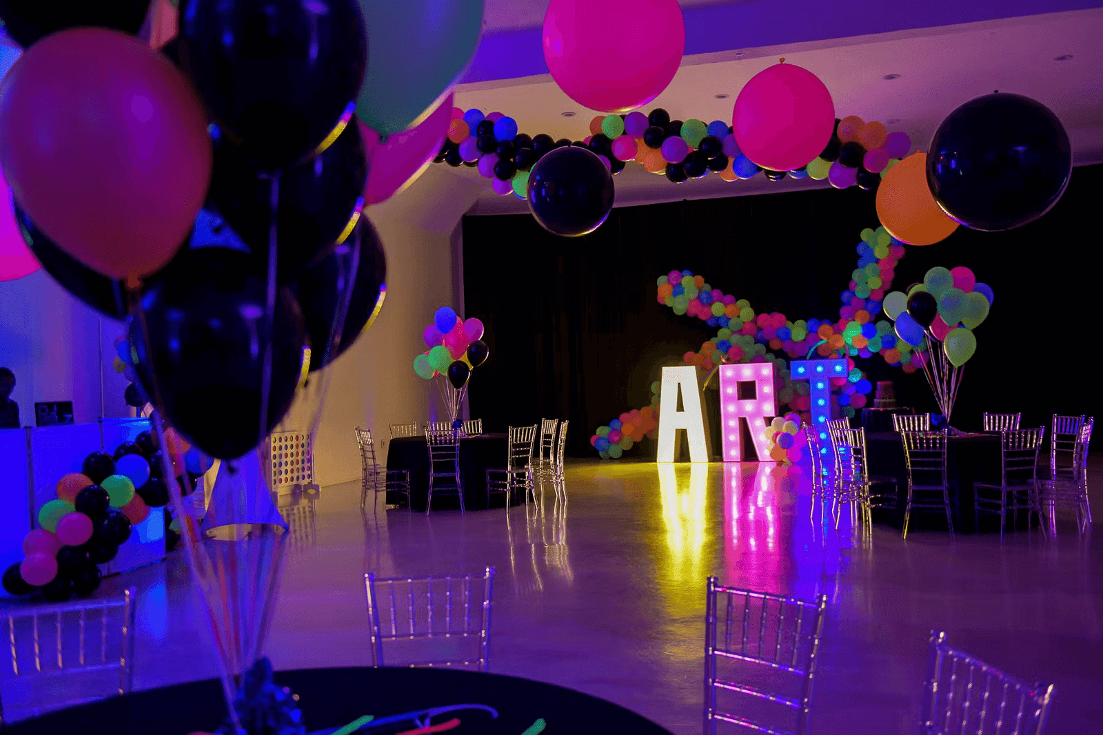 Kids celebrating in neon themed birthday party room with AR interactive walls at Singapore mall Kids celebrating in neon themed birthday party room with AR interactive walls at Singapore mall